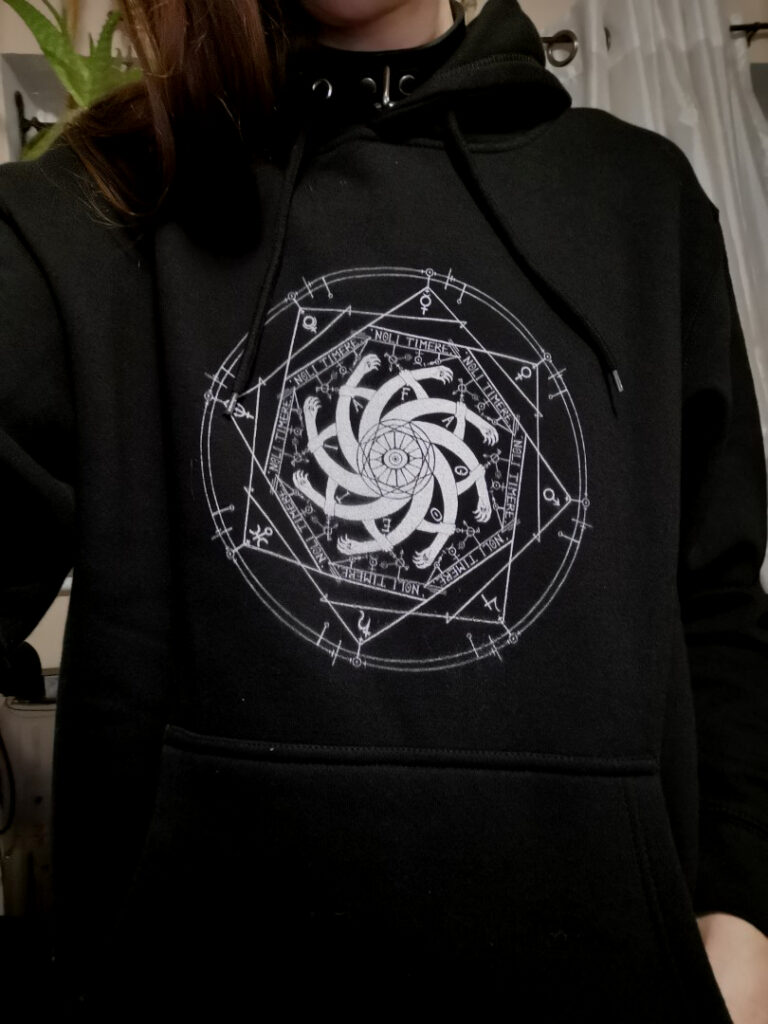photo of a black hoodie with the fagoetic seal screenprinted upon the front.