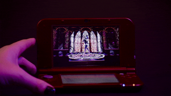 video gif of a nintendo 3DS rotating to the left and right, the dilapidated church scene and deer displayed on its lenticular screen rotating in parallax.